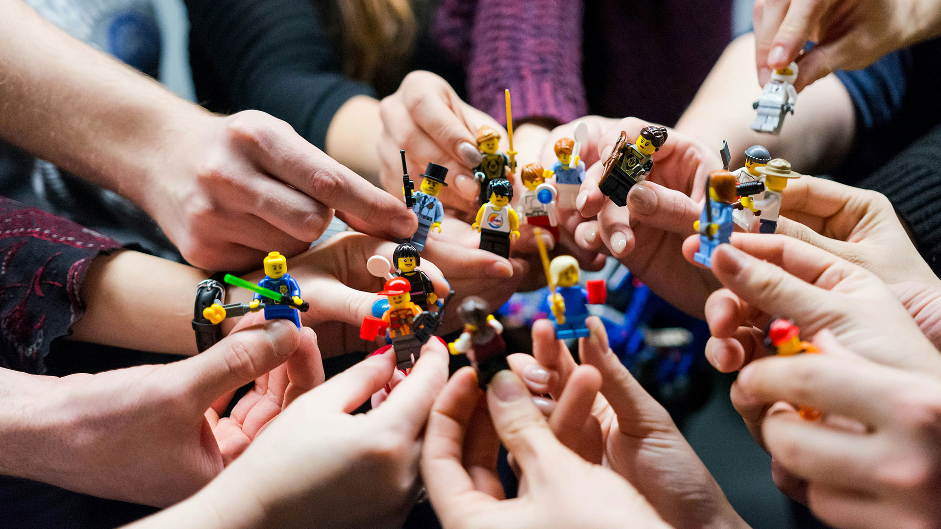 Ignition People holding various Lego figures, photo by vlad hilitanu